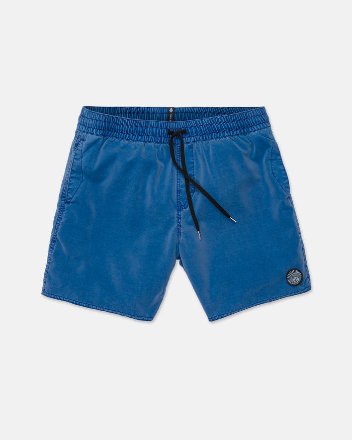 The Volcom Men's Center Elastic Waist Trunks are 17-inch boardshorts designed with a blue drawstring and an elastic waistband. They feature two side pockets and a small circular patch near the left hem, all presented laid flat on a white background for a clean, stylish look.
