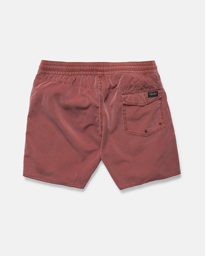 Back view of Volcom Men's Center Elastic Waist 17" Trunk in faded red, featuring an elastic waistband, mechanical stretch, and a single back pocket with a black and white label. Shorts are laid flat on a white background.