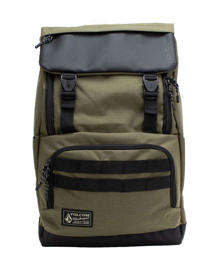 The Volcom Men's Charter Ruck Backpack in olive green and black features a top flap with two front buckles, a zippered front pocket, and a label patch at the bottom. This workwear-inspired backpack is designed with black straps and zipper pulls, offering a sturdy rectangular shape that’s perfect for everyday use or securely carrying your laptop.