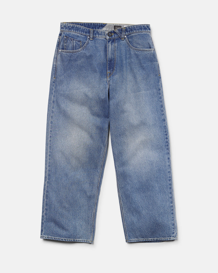 Presenting the Volcom Men's Chillow Denim Pants in Euro Light Blue—these relaxed, wide-leg jeans feature front pockets and a button closure, laid flat on a white background. With their baggy low-rise fit, the Chillow Denim Pants deliver effortless style and comfort to any casual wardrobe.