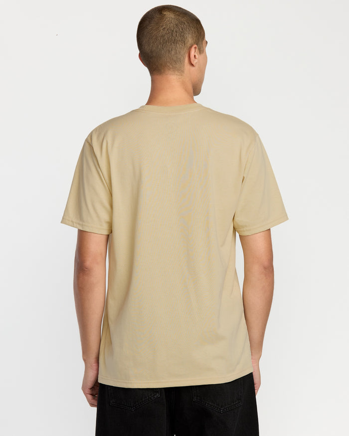 A person with short hair is seen from behind wearing the Volcom Men's Circle Stone Short Sleeve Tee and black pants, standing against a plain white background.