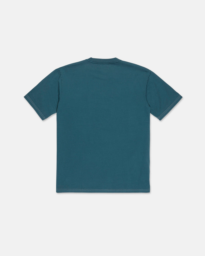 The Volcom Men's Crassy Short Sleeve Tee in teal is displayed laid flat with the back side facing up against a white background. This loose fit premium cotton t-shirt features short sleeves for comfort and versatility.