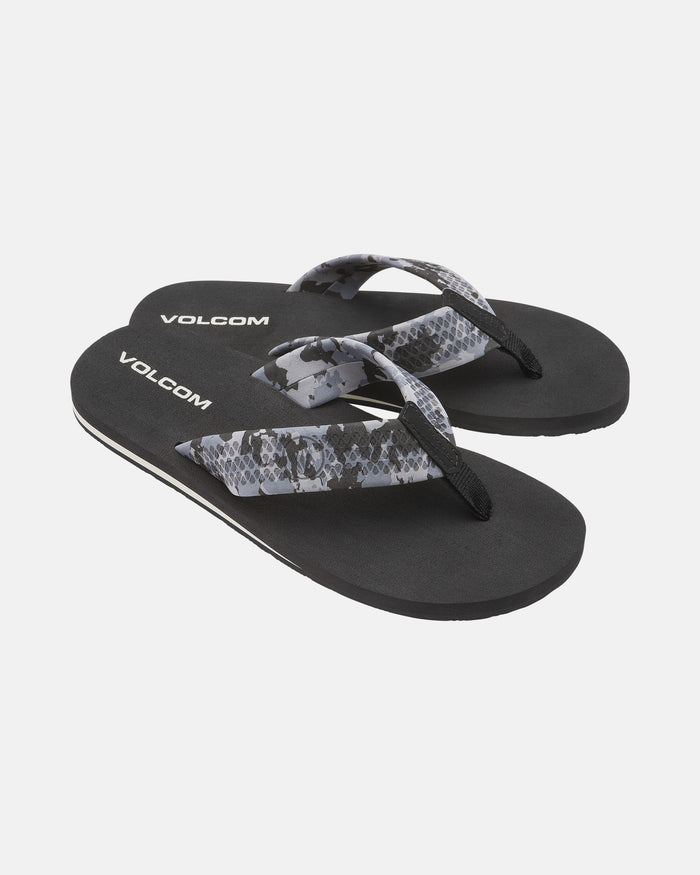 A pair of Men's Daycation 2 sandals by Volcom, black with gray and black snakeskin-patterned straps and a molded rubber outsole, shown on a white background.