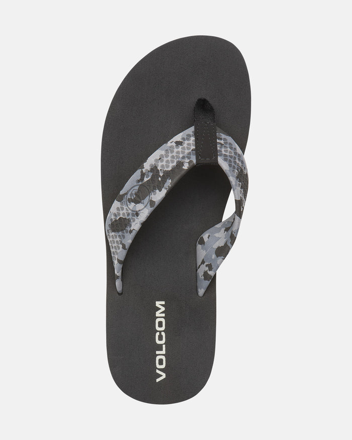 A single black Volcom Men's Daycation 2 sandal with a gray and black patterned strap and white VOLCOM branding on the EVA footbed, plus a molded rubber outsole, displayed on a plain white background.