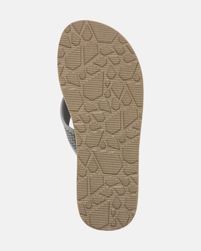 The image shows the sole of Volcom Men's Daycation 2 EVA sandal flip-flop with a beige, textured geometric and sailboat pattern. The rubber outsole contrasts against the white background.