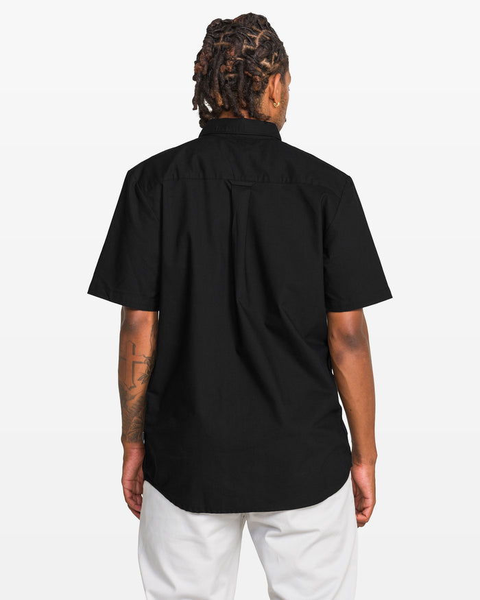 Person wearing a black short-sleeve shirt on a white background