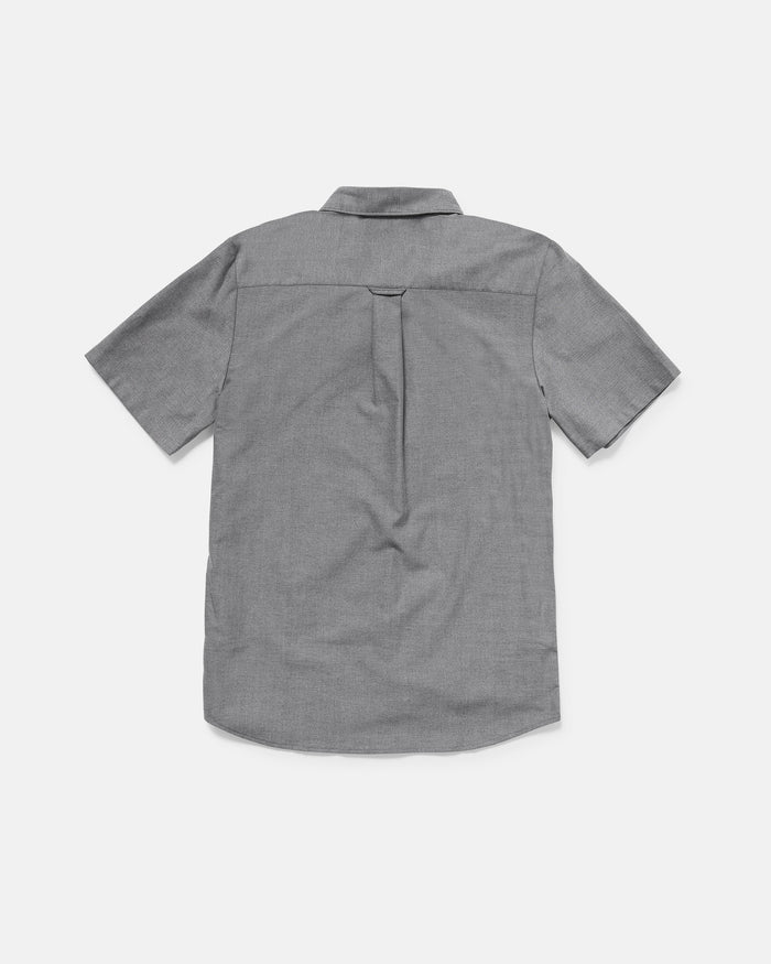 Back view of the Volcom Men's Everett Oxford II short sleeve, light gray button-up shirt with a collar and center back pleat. The classic fit oxford is laid flat on a white background.