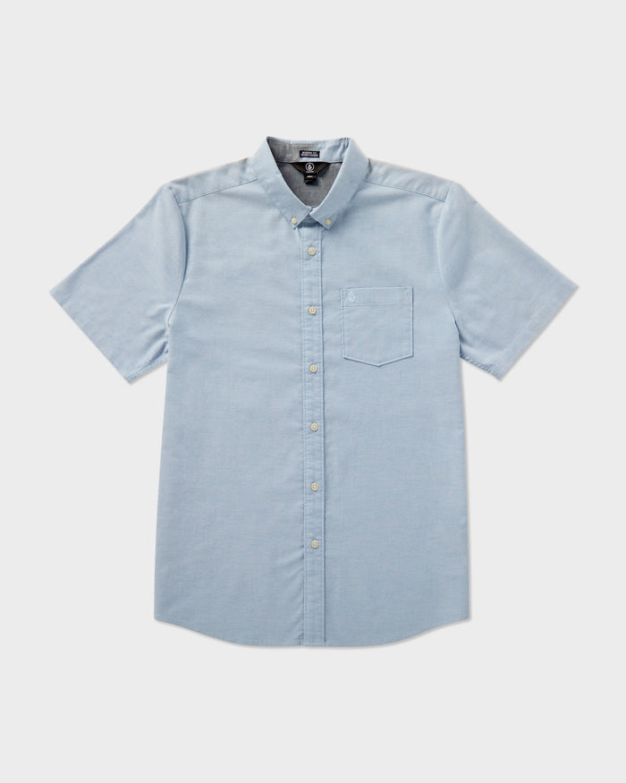 The Volcom Men's Everett Oxford Short Sleeve shirt in light blue features a slim fit, button-down collar, and chest pocket, shown flat on a white background.