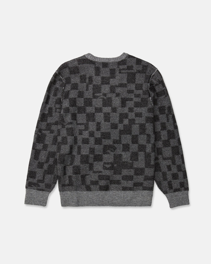 Volcom Men's Featured Artist Antonio Carrau Sweater in gray jacquard with a black checkered pattern, shown from the back. Designed with ribbed cuffs, hem, and neckline for added comfort, this cozy sweater features a boxy fit for effortless style.