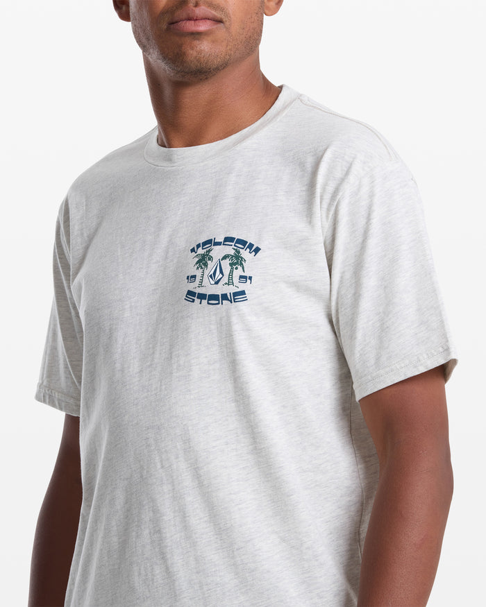 A man wearing the Volcom Men's Fed Up Short Sleeve Tee, a classic fit shirt made from 100% cotton.