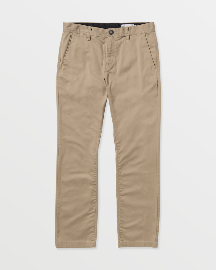 Men’s Frickin Modern Stretch Pants by Volcom in beige khaki, crafted from recycled polyester with button and zip fly, side pockets, and belt loops, shown laid flat on a white background.