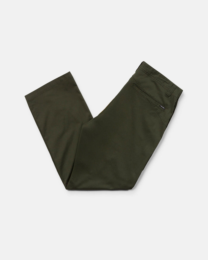 A pair of Volcom Men's Frickin Modern Stretch Pants in olive green, neatly folded in half with a rear zipper pocket visible, crafted from REPREVE recycled fibers and displayed on a white background.