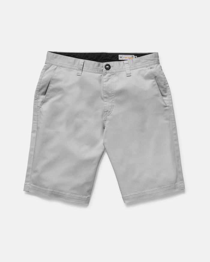 The Volcom Men's Frickin Modern Stretch Shorts in light gray feature breathable cotton-poly fabric, knee-length cut, side pockets, belt loops, and a front button with zipper closure, shown on a plain white background.