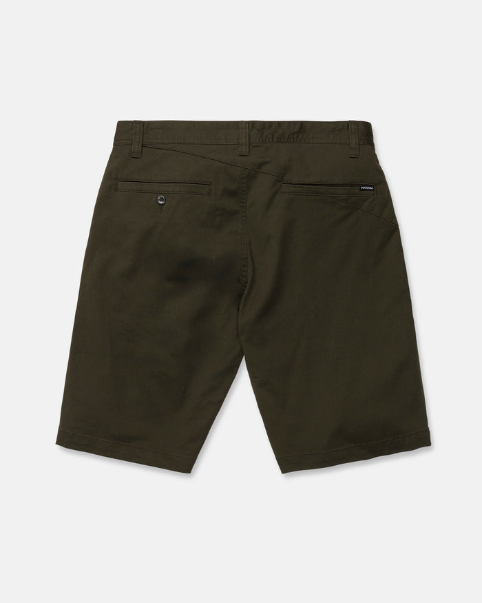 Back view of the Volcom Men's Frickin Modern Stretch Shorts in dark green (olive), featuring knee-length cotton-poly stretch fabric, belt loops, two back pockets—one with a button—and a small black tag near the waistband, crafted from breathable material and shown against a white background.