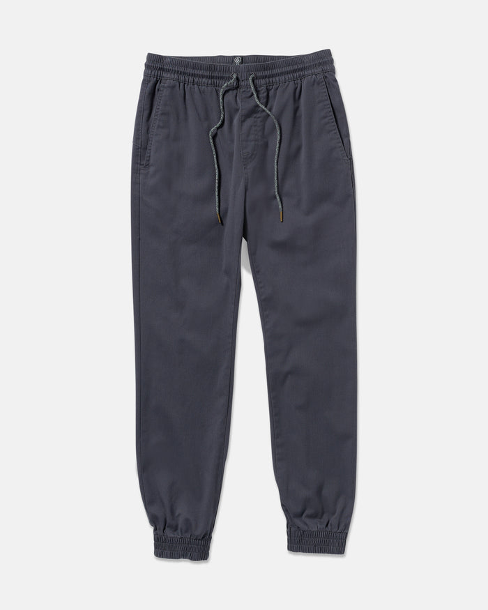 The Volcom Men's Frickin Slim Joggers in dark gray feature REPREVE recycled fibers, an elastic waistband with drawstring, side pockets, and elastic cuffs, shown laid flat on a white background.