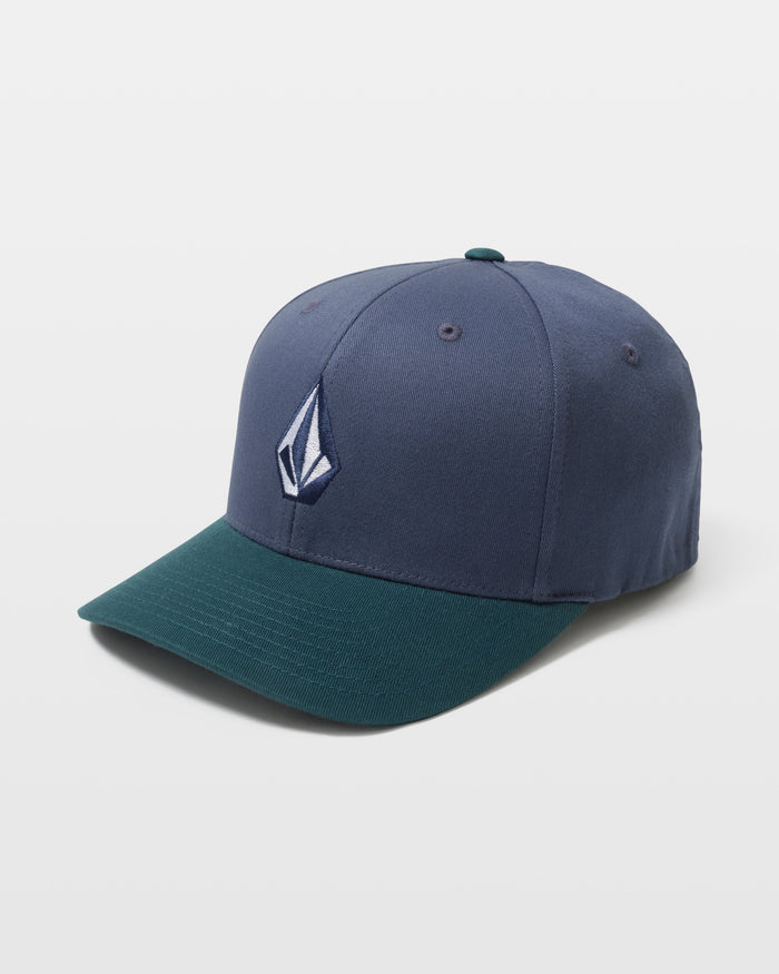 The Volcom Men's Full Stone Flexfit Hat features a blue crown, dark green brim, and a white embroidered geometric logo on the front, making it a stylish and comfortable addition to any men's hat collection.