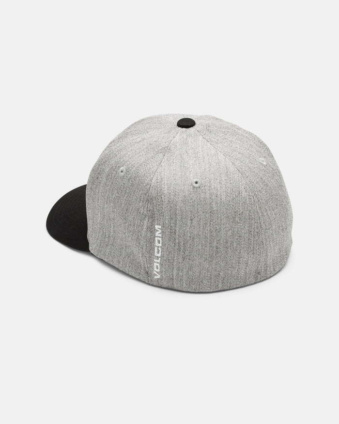 The Volcom Men's Full Stone Heather Flexfit Hat is displayed from the back angle, featuring a gray structured stretch twill design with a black brim. "VOLCOM" is printed vertically in white on the side near the back. The cap is set against a plain white background.