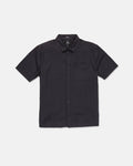 The Volcom Men's Glasnow Short Sleeve Shirt, shown laid flat on a white background, features a black cotton fabric with a subtle small yarn-dyed checkered pattern, button-up front, flat collar, and chest pocket.
