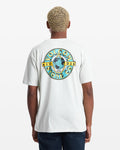 A person with short, light blonde hair is seen from the back wearing the Volcom Men's Globular Short Sleeve Tee, a white shirt featuring a colorful circular logo with a hand holding a globe and "Volcom Stone Co. 1991" text.