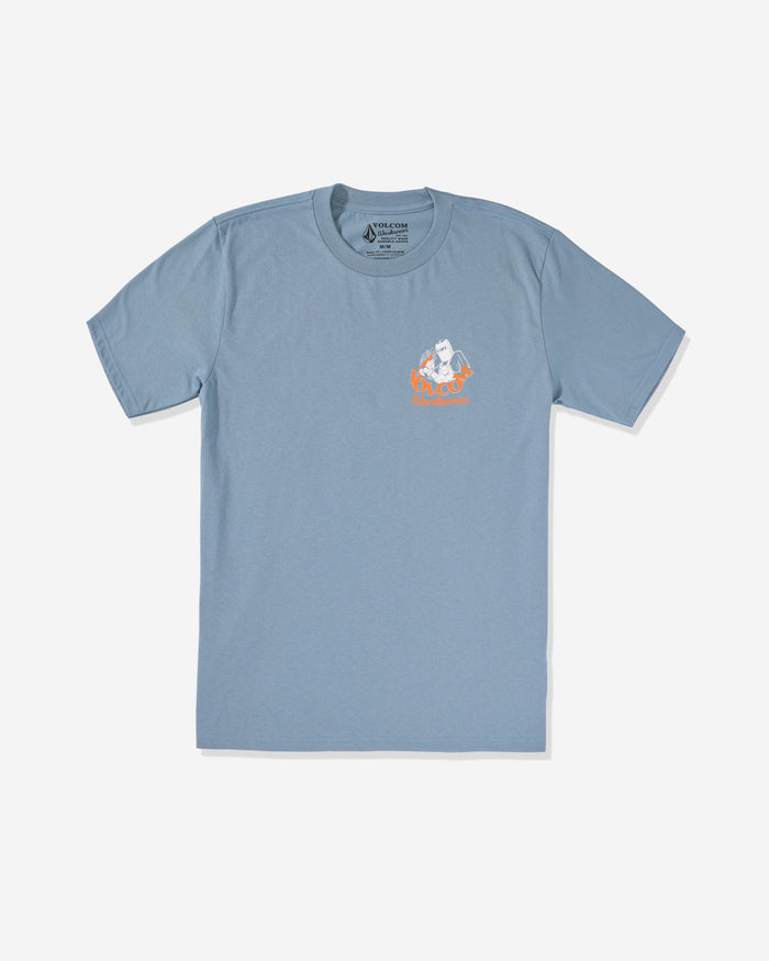 The Volcom Men's Grindit Short Sleeve Tee in light blue is made from 100% cotton and features a small graphic of a white cartoon cat on orange flames on the left chest, shown against a plain white background.