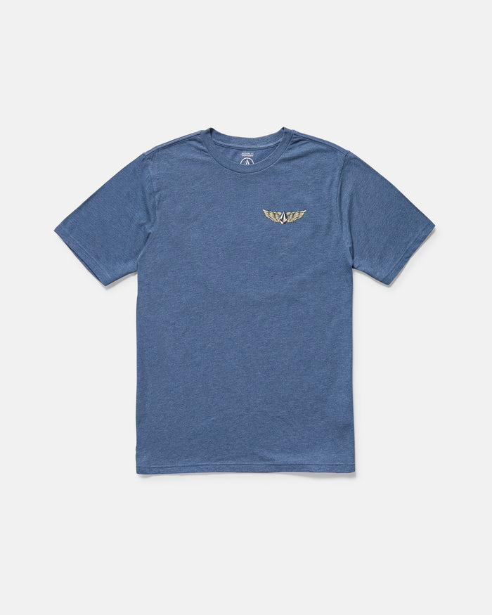 The Volcom Men's Hi Flyer Short Sleeve Tee is a blue modern fit top made from soft ring spun cotton, with a small gold winged emblem on the left chest, shown against a plain white background.