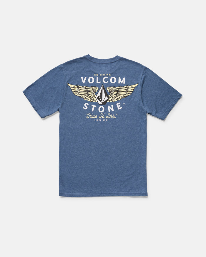 The Volcom Men's Hi Flyer Short Sleeve Tee is a blue modern fit shirt featuring a back graphic of yellow wings and bold "The Original Volcom Stone" and "True To This Since 1991" text in white and yellow.