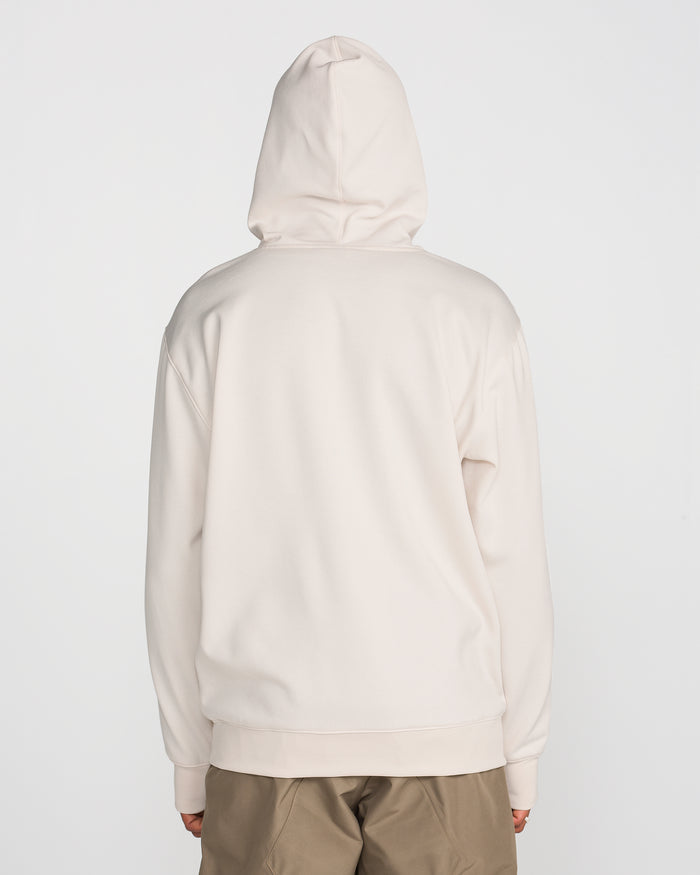 A person wearing a light beige Volcom Men’s Hydro Riding Hoodie with the hood up and khaki pants, shown from the back against a plain white background. This stylish hoodie by Volcom features hydrophobic fleece, offering both comfort and protection from the elements.