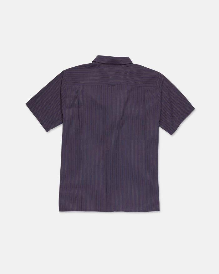 The Volcom Men's Kap Out Workwear Short Sleeve Shirt is a collared, button-up shirt shown from the back. Inspired by Volcom Workwear, this durable piece features a dark finish with thin, subtle vertical stripes on a light background.