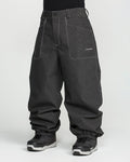A person is wearing Volcom Men’s Lapper Pants in a loose-fitting, dark gray style with white stitching and gathered hems at the ankles. The pants feature the Volcom logo on the pocket and are paired with a black shirt and black and gray sneakers. The background is plain white.