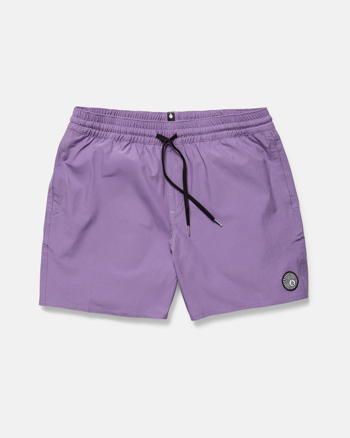 The Volcom Men's Lido Solid 16" Trunk in light purple features a black drawstring, elastic waistband, side pockets, and a circular patch on the left leg. The swim shorts are shown laid flat on a white background.