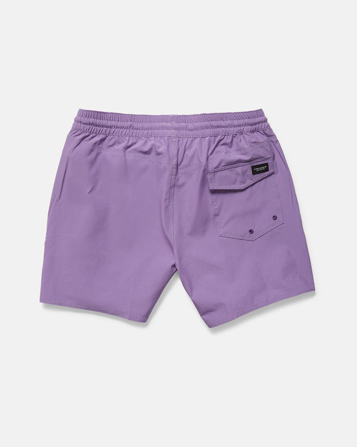 The Volcom Men's Lido Solid 16" Trunk, in purple recycled polyester, features an elastic waistband, two side pockets, and a back flap pocket with button and black label. The swim trunks are laid flat on a white background.