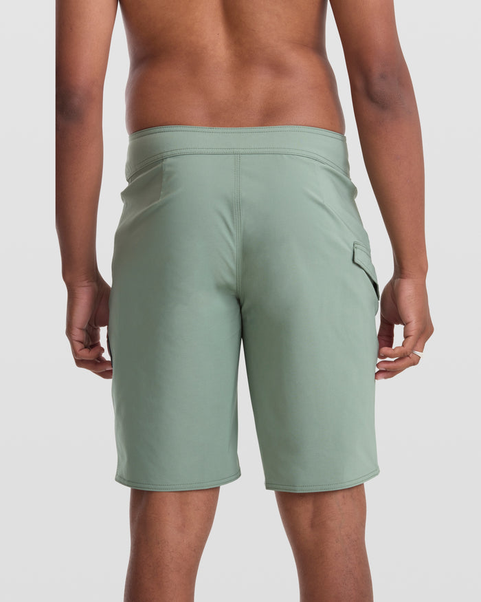 A person wearing Volcom Men's Lido Solid 20" Trunks with 4-way stretch fabric.