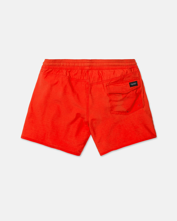 The Volcom Men's Lido Solid Trunks in bright red are displayed from the back, highlighting an elastic waistband and a single back pocket adorned with a small black label. Made from recycled polyester and featuring a 16-inch outseam, these swim trunks are laid flat on a white background.