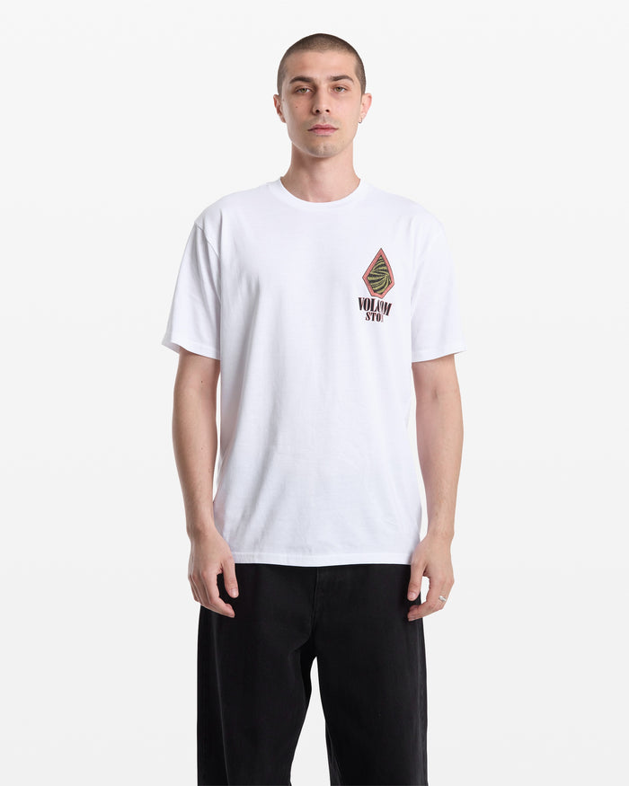 A man with short hair wears the Volcom Men's Mindsign Short Sleeve Tee, a slim fit all-cotton shirt featuring a small graphic and Volcom text on the left chest, paired with black pants—ideal for easy everyday style.