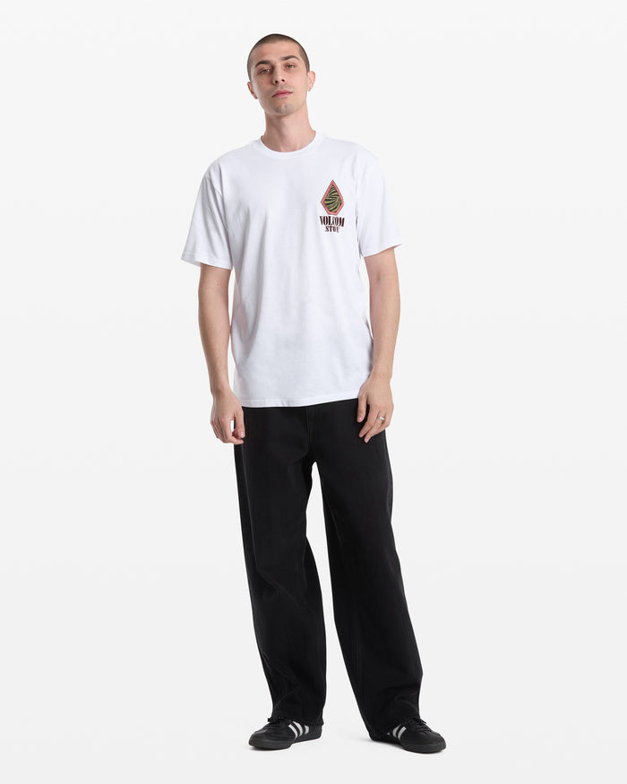 A person stands against a white background, wearing the Volcom Men's Mindsign Short Sleeve Tee with a small chest logo, paired with black pants and black sneakers with white stripes—an ideal choice for effortless everyday wear.