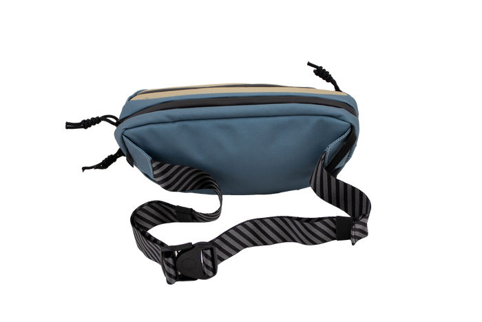 The Volcom Men's Mini Dos Pack Waist Bag features a blue design with a black-and-gray striped adjustable strap and buckle, showcased on a plain white background.