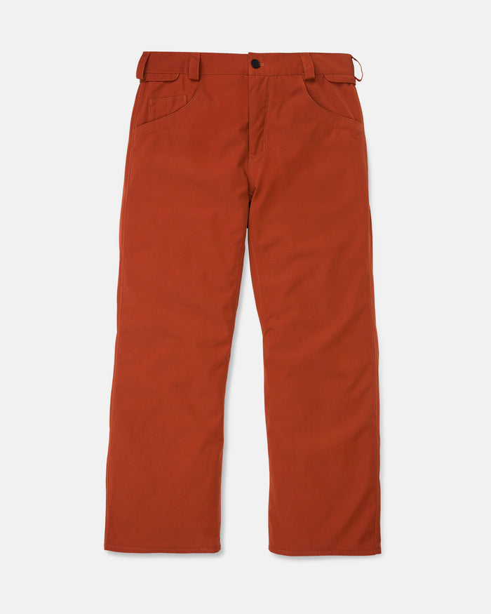 The Men’s Nailer Pants by Volcom in a bright rust color are made from recycled materials and feature belt loops, a button and zipper closure, front pockets, and a straight-leg fit, displayed flat on a white background.