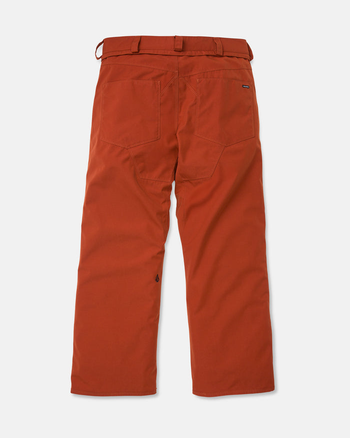 The back view of a pair of Volcom Men’s Nailer Pants in burnt orange, featuring two rear pockets, belt loops, and a straight leg cut, made from recycled fabric and displayed flat against a white background.