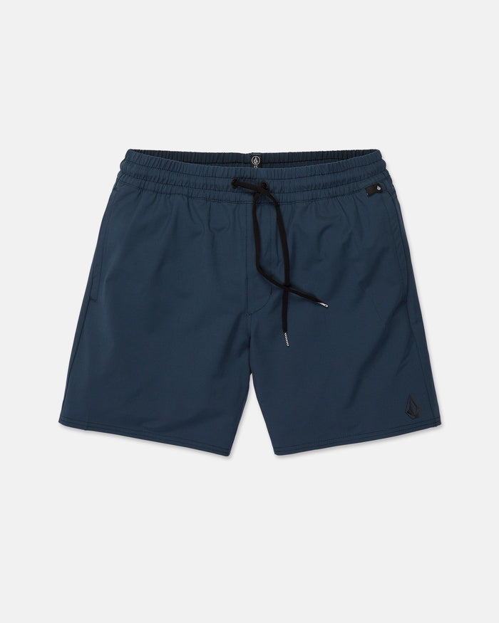 The Volcom Men's Nomoly Elastic Waist Shorts in navy blue feature an elastic waistband with a black drawstring, convenient side pockets, and a subtle logo on the lower left leg. Made from a recycled blend fabric with 4-way stretch for exceptional comfort and flexibility, these shorts are displayed against a white background.