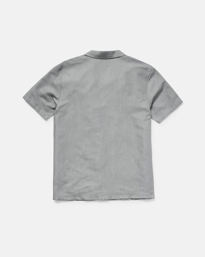 The Men's Otis Stone Short Sleeve Tee by Volcom, featuring a boxy fit and light gray color, is displayed from the back on a plain white background.