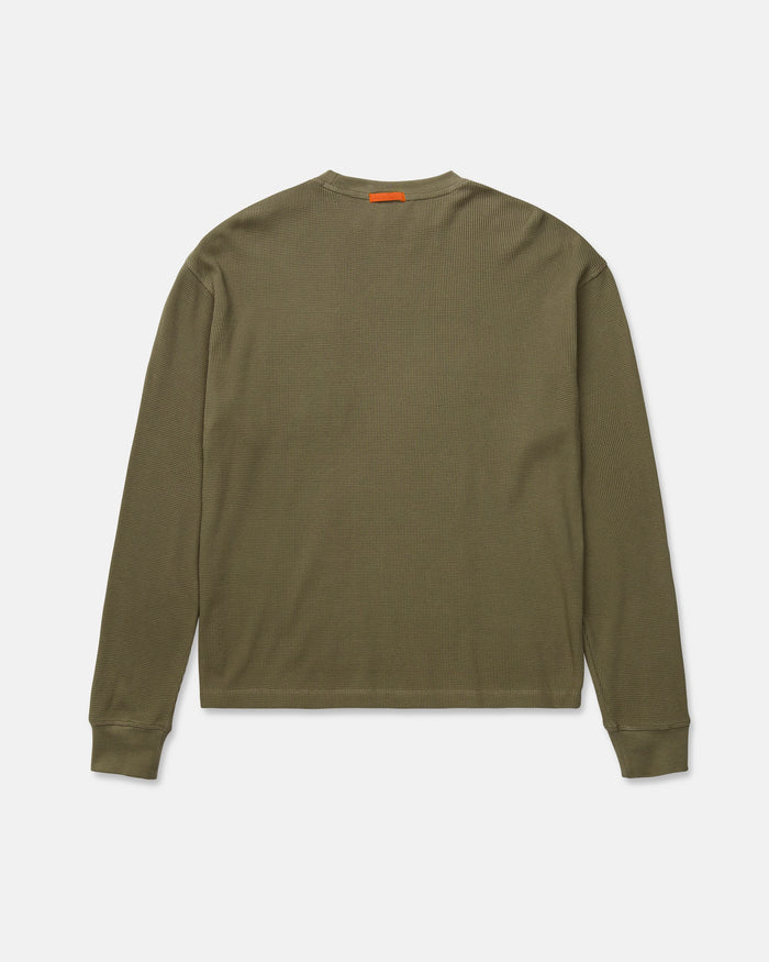 Volcom Men's Overtime Workwear Thermal Long Sleeve Shirt in olive green, shown from the back, features ribbed cuffs and a small orange tag near the collar. Made from soft cotton knit fabric, this thermal shirt delivers comfort and durability for demanding workwear needs.