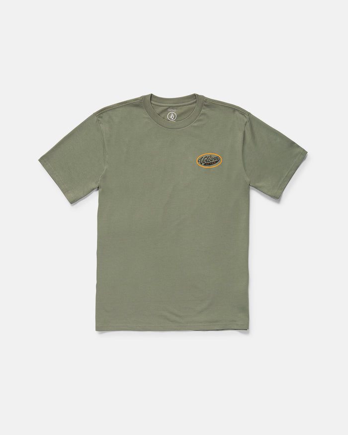 The Volcom Men's Parts And Services Short Sleeve Tee is an olive green, classic fit t-shirt with a small black and yellow logo patch on the left chest. Made from organic cotton, it's shown laid flat on a white background.