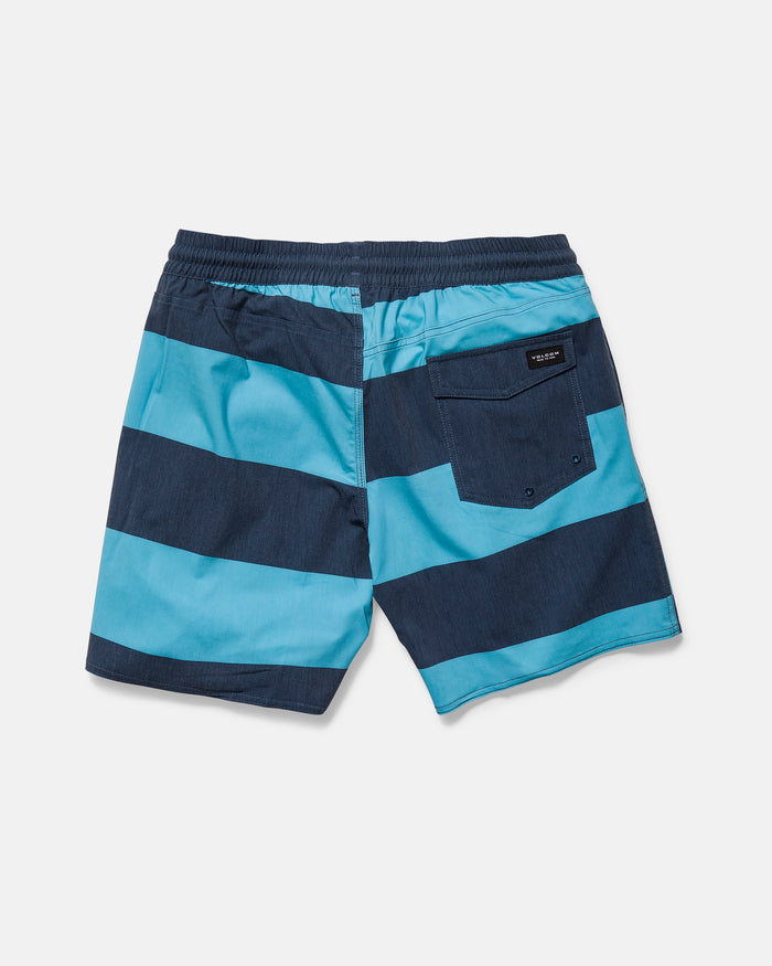 The Volcom Men's Psyche Cotton 17" Trunk features blue and navy stripes, an elastic waistband, single back pocket with a black label, and is shown laid flat, back view, on a white background.