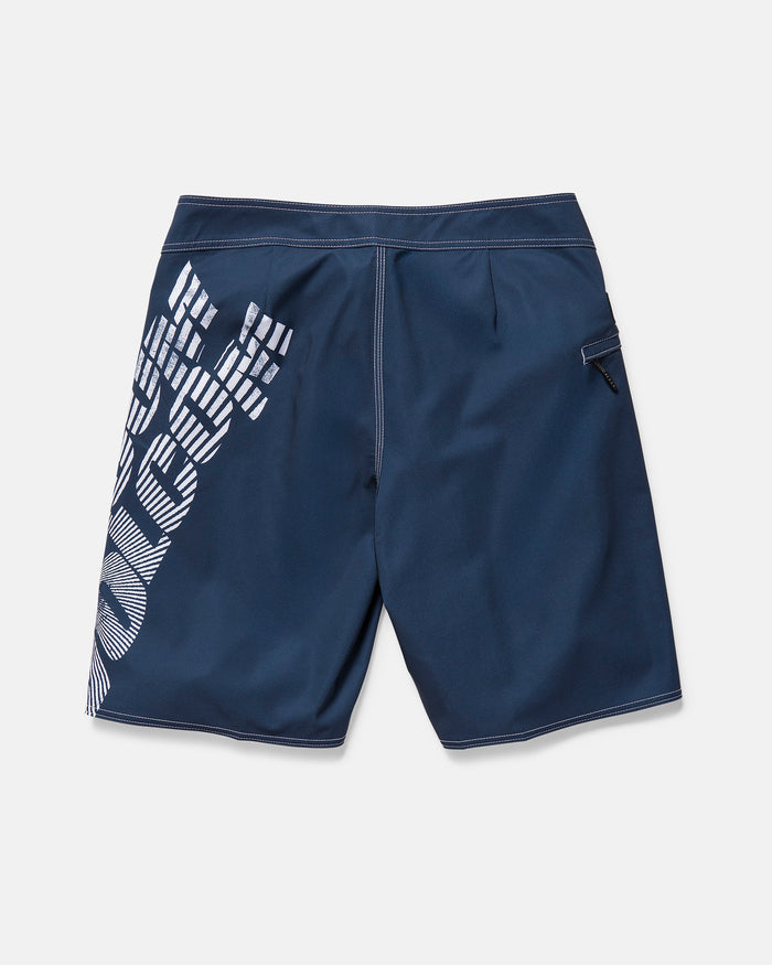 The Volcom Men's Reaper Mod 21" boardshort features a midnight blue color, white geometric graphic on the left, white stitching, zippered back pocket, and REPREVE 4-way stretch fabric for comfort and durability. Displayed on a plain background.