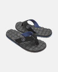 A pair of black Volcom Men's Recliner flip-flops featuring extra-grippy, textured woven-pattern soles and blue-lined straps, shown on a plain white background.