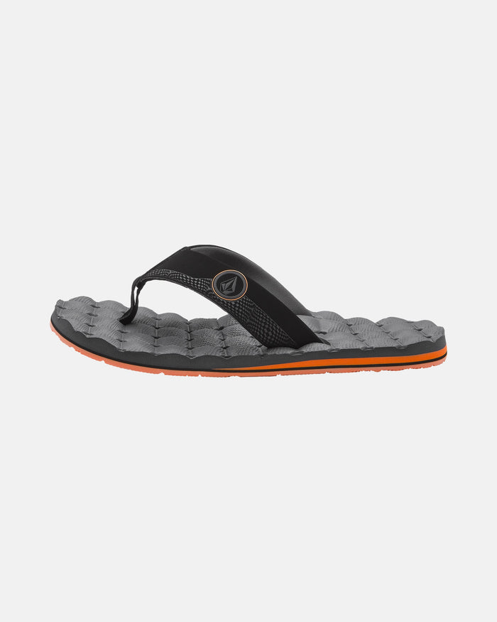 The Volcom Men's Recliner is a black and gray flip-flop with an orange sole, quilted cushy footbed, and a black strap with a small round logo—ideal for those wanting stylish comfort.