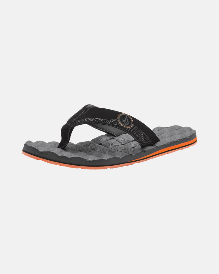 A single black and gray Volcom Men's Recliner flip-flop with a textured, cushy sole and an orange accent stripe around the edge is displayed on a plain white background.