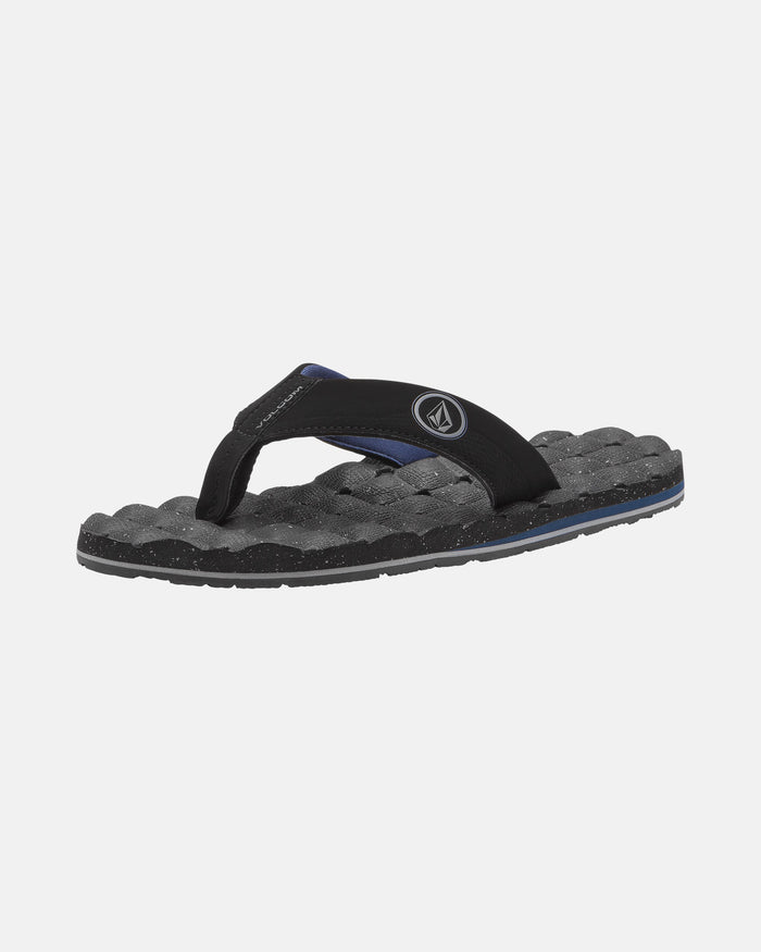 The Volcom Men's Recliner flip-flop features a cushy, textured black and gray sole with a black fabric strap and small circular logo, shown against a plain white background.