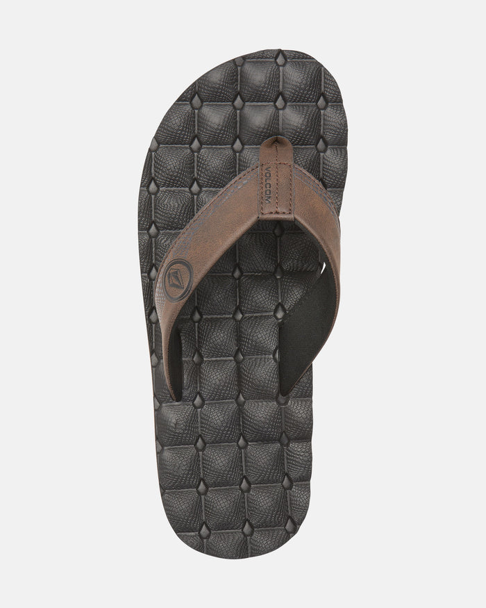 A single brown Volcom Men's Recliner sandal with thick straps and an extra grippy, textured black sole, shown from above on a plain white background.
