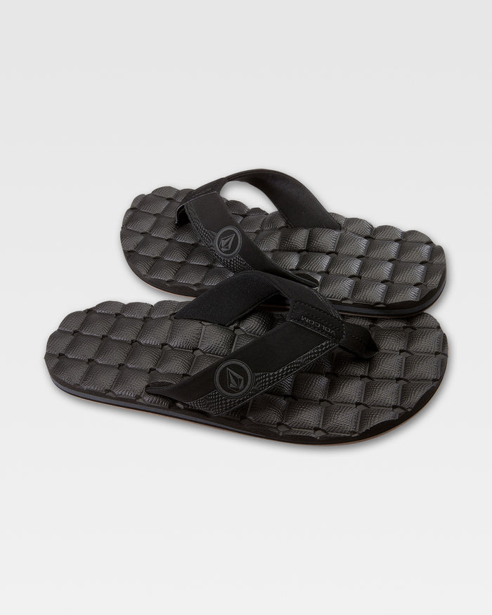 The Volcom Recliner sandals feature thick straps and a cushy, woven-pattern sole for a comfortable, grippy step—shown here in black against a plain white background.